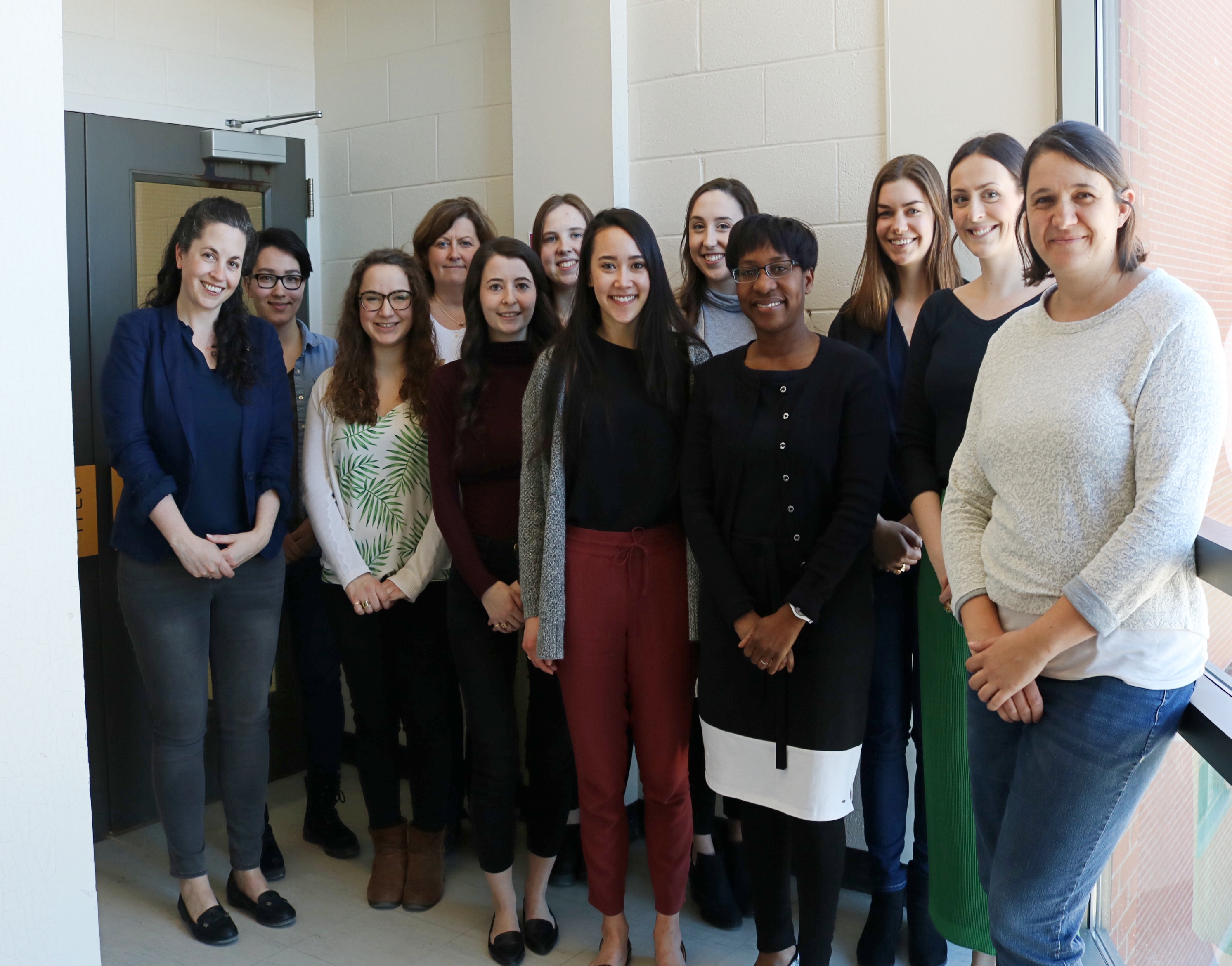 Group of people standing and smiling for photo