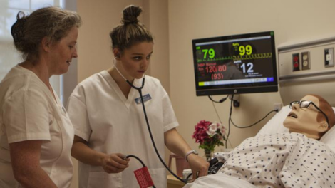 Nursing students working with a simulated patient