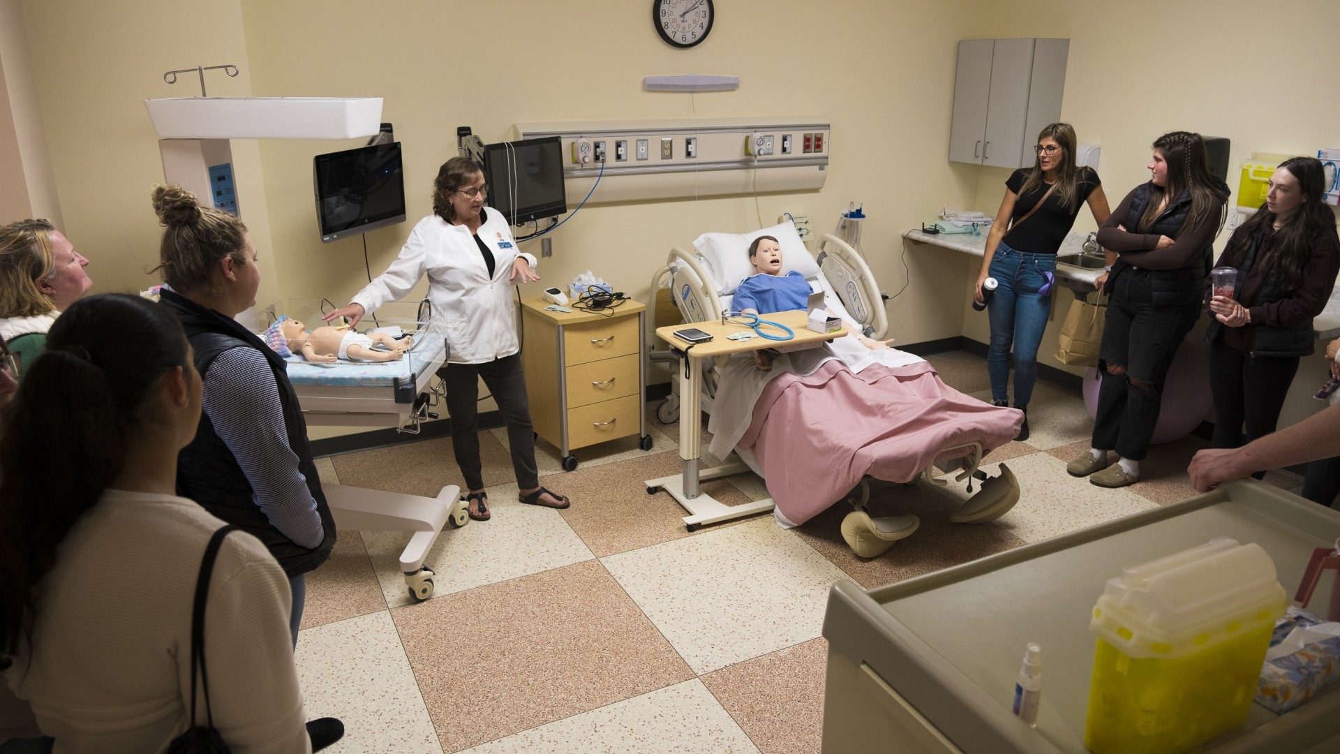 Nursing professor giving a tour of the StFX Nursing Sim Lab during Open House 2024
