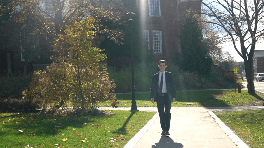 A business student walking through campus