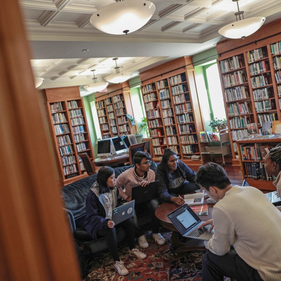 Students studying while sitting on couches in the Coady International Institute library.