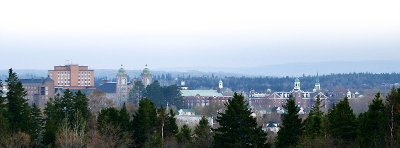 StFX campus, showing the mountains in the background and surrounded with trees