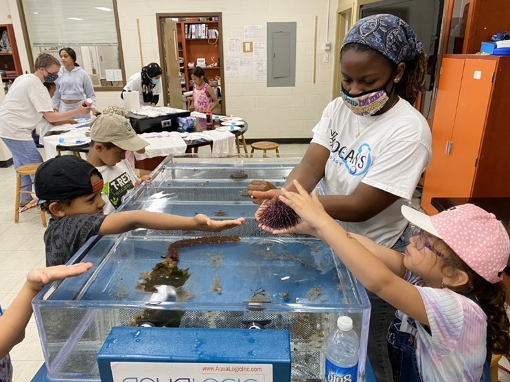 School Students Holding Sea Animals