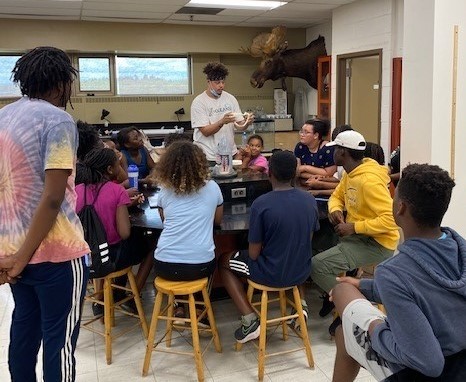 Student Leader Instructing Student On Lab