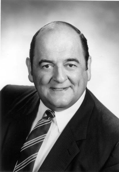 A black and white photo of a man in a suit and tie