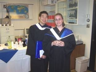 Two graduated students. One boy in the left, one girl in the right.