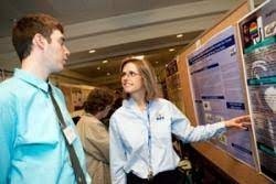 A person showing something on display to another person