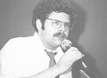 Picture of Young Ken Nielse Speaking Through a Microphone